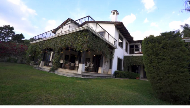 Estate exterior with sweeping lawn
