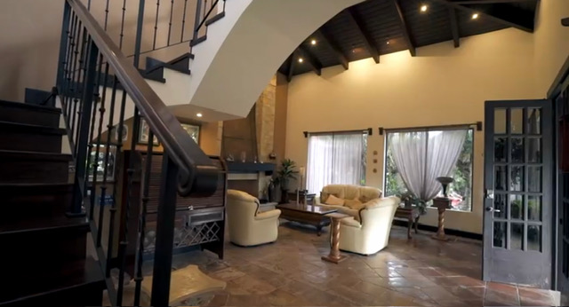Vaulted living room with grand staircase